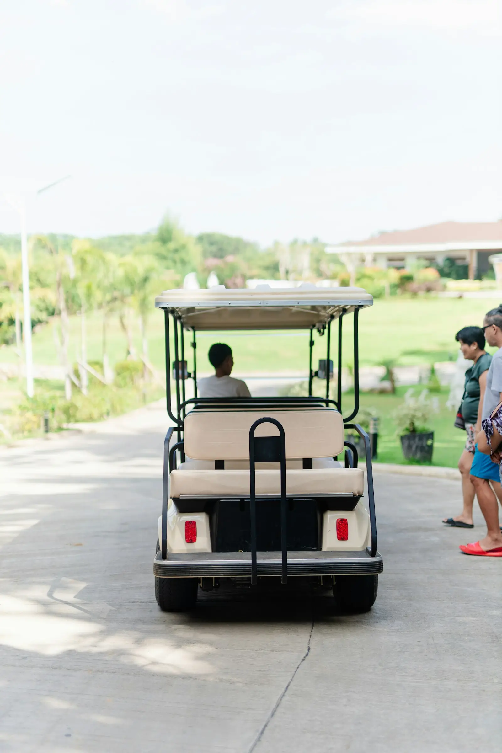 Golf cart buyers riding through a city course